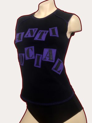 Black woman’s sleeveless babydoll tank top with purple overlocked stitching and purple Anti Social stencilled appliqué lettering across the front.