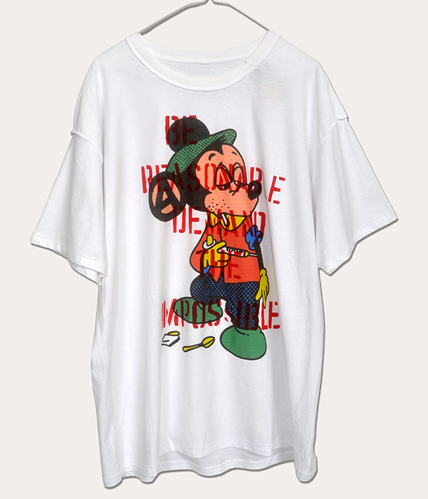 White men’s XL Seditionaries style punk T-shirt worn inside out, featuring a colourful cartoon figure with red Be Reasonable Demand the Impossible lettering and hand-stencilled details.