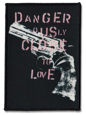Black sew-on punk patch with distressed handgun graphic and pink text reading “Dangerously Close to Love”
