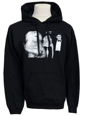 Black Divine Trump Unisex Hoodie showing Divine glaring at Trump and a blonde woman in a monochrome print on the chest.