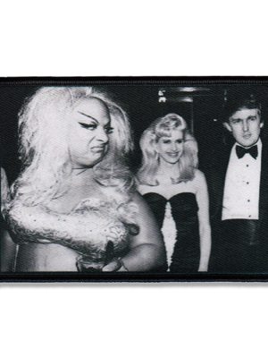 Black rectangular sew-on patch featuring a black and white photo design with three figures in a candid scene.