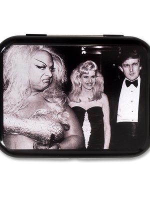 Glossy black metal tin featuring a black and white photo of Divine, a blonde woman and Donald Trump on the lid.