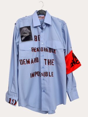 Men’s Seditionaries reproduction punk shirt in light blue with stencilled slogan text, graphic portrait patch, and red armband detail