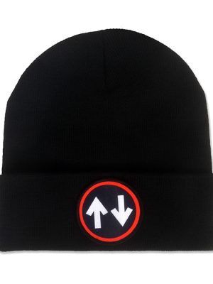 Black knitted mod beanie hat with folded cuff and circular black patch featuring two opposing white arrows surrounded by a bright red border.
