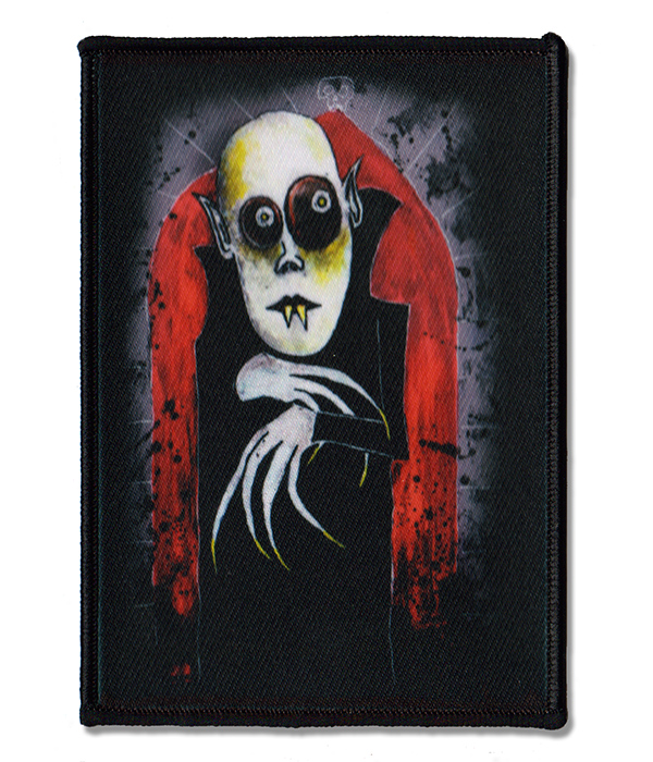 Nosferatu gothic horror printed sew-on patch with Paul Raggity artwork, showing a pale vampire with dark eyes and long claws against a distressed red arch.