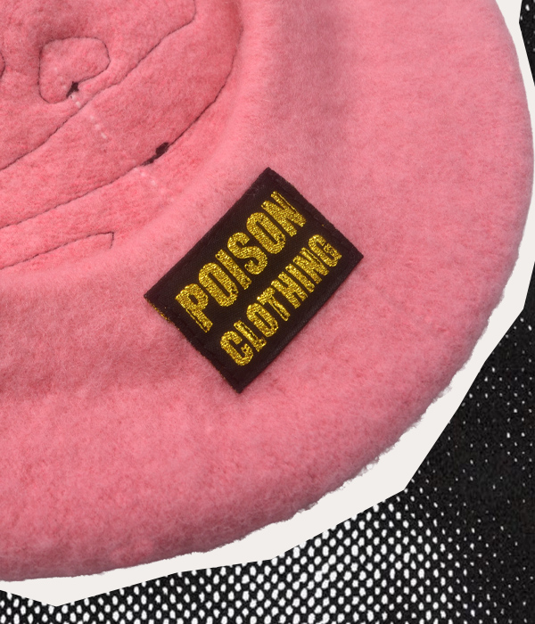 Gold woven Poison Clothing branded label sewn inside a handmade pink beret.