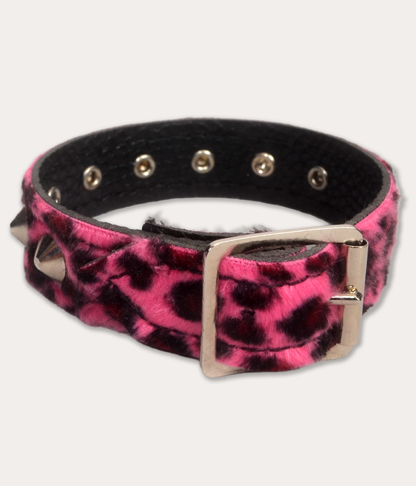 Rear view of a pink and black leopard print studded wrist cuff showing its silver-tone buckle fastening and adjustable eyelets.
