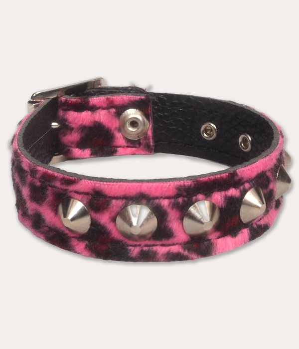 Hot pink and black leopard print punk wrist cuff with a soft furry finish, chunky silver-tone cone studs and black inner lining.