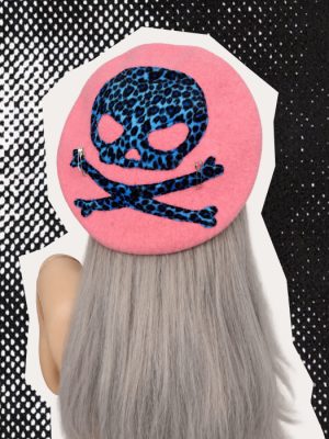 Pink handmade beret with blue and black leopard print skull and crossbones and silver safety pin details.