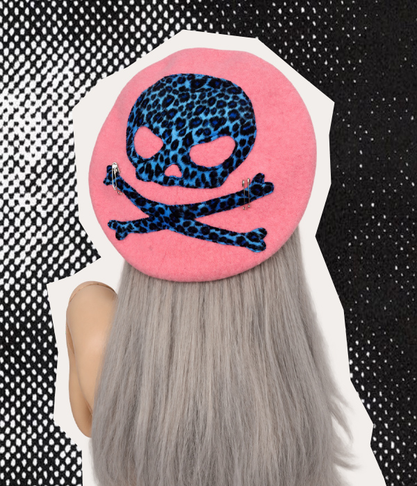 Pink handmade beret with blue and black leopard print skull and crossbones and silver safety pin details.