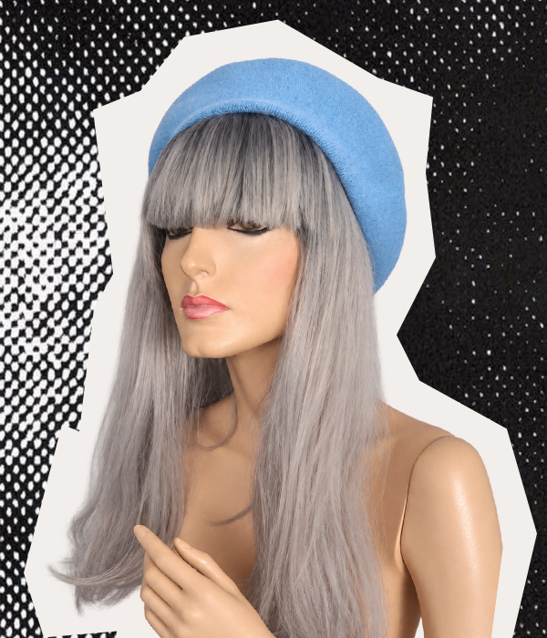 Plain powder blue side of handmade beret worn on a mannequin with long silver hair