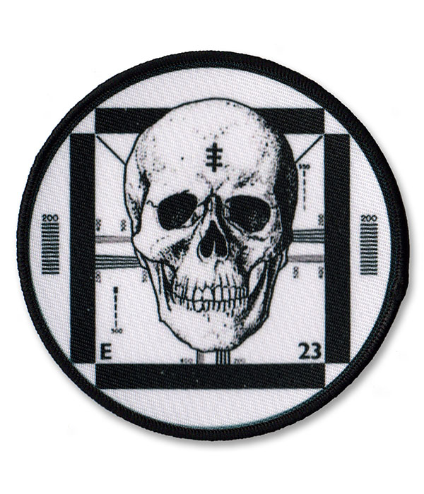 Round Psychic TV sew-on patch featuring black and white skull over a vintage TV test card design.