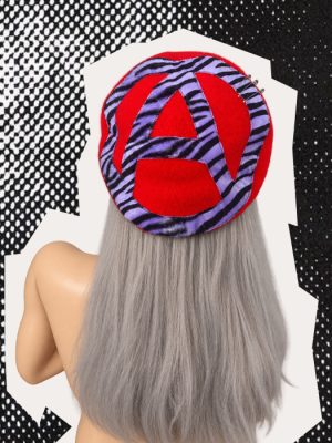 Handmade red punk beret with purple and black zebra-print anarchy symbol and silver safety pins