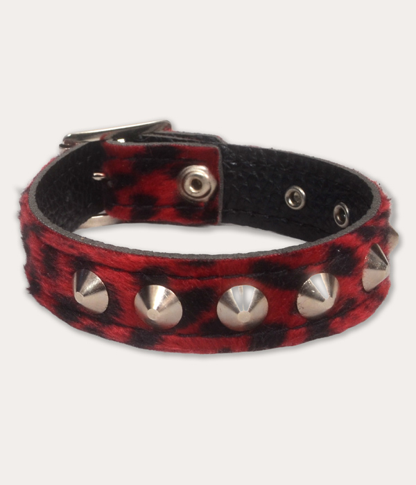 Front image: Red and black leopard print punk wrist cuff with silver-tone cone studs, black inner lining and adjustable metal fastening.