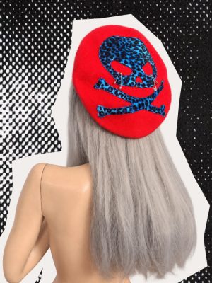 Handmade red punk beret with electric blue and black leopard-print skull and crossbones and silver safety pins