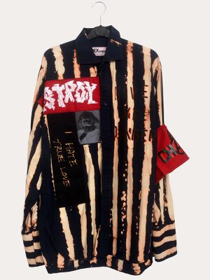 Men’s Seditionaries reproduction punk shirt with distressed black and cream stripes, slogan graphics, and armband detail hanging on a rail