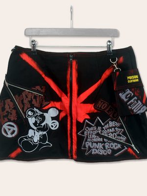 Red and black Seditionaries-inspired mini skirt with front zip, bold punk graphics, patches, and a detachable pocket.