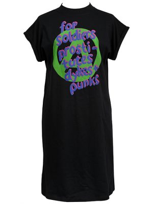 Black women’s t-shirt dress with green and purple punk text reading “for soldiers, prostitutes, dykes + punks” in a bold graffiti style.