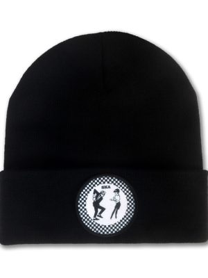 Black knitted ska beanie hat with folded cuff and circular black and white checkerboard patch featuring two dancing ska figures.