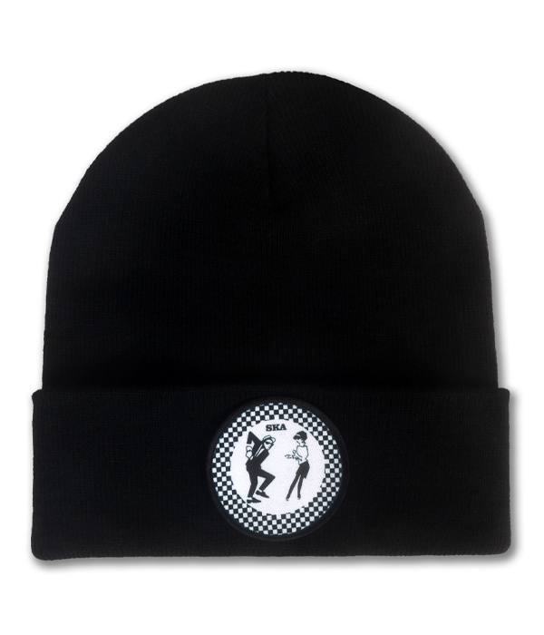 Black knitted ska beanie hat with folded cuff and circular black and white checkerboard patch featuring two dancing ska figures.