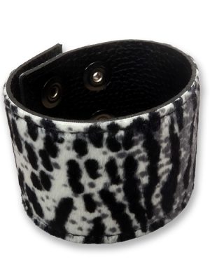 Snow leopard print wrist cuff made from faux fur and black PU leather, shown fastened with adjustable press studs.