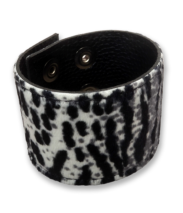 Snow leopard print wrist cuff made from faux fur and black PU leather, shown fastened with adjustable press studs.