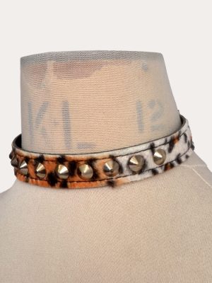 Leopard print adjustable punk collar with silver-tone cone studs, shown on a mannequin and laid flat with buckle fastening.