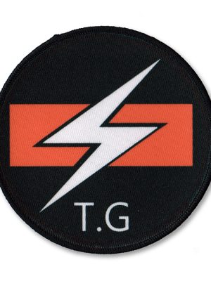 Round Throbbing Gristle sew-on patch with white lightning bolt and orange bar logo on black background.