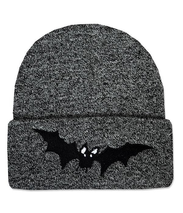 Mottled black and grey knitted beanie hat with wide folded cuff featuring a black embroidered vampire bat with outstretched wings and small white eyes.