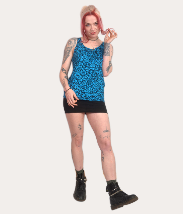 Woman wearing a blue leopard print tank top, punk sleeveless vest, alternative women’s clothing, made in the UK.