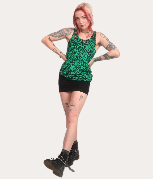 Woman wearing a green leopard print tank top, punk sleeveless vest, alternative women’s clothing, made in the UK.