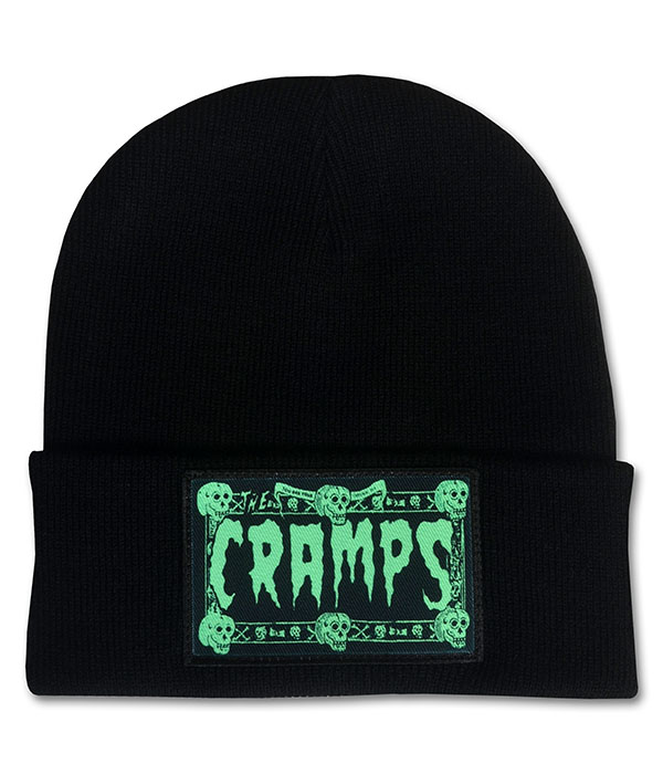 Black cuffed beanie hat featuring a green The Cramps skull logo patch on the front, psychobilly punk winter accessory.